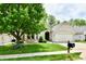 Lovely one-story brick home with an attached garage and mature landscaping and big tree at 10713 Stable Dr, Indianapolis, IN 46239