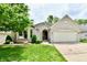 Charming single story home featuring a well-manicured front yard and attached garage at 10713 Stable Dr, Indianapolis, IN 46239