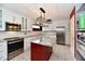 Stylish renovated kitchen features an island, white cabinets, and stainless steel appliances at 10713 Stable Dr, Indianapolis, IN 46239
