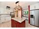 Spacious kitchen featuring an island, stainless steel appliances, white cabinets, and recessed lighting at 10713 Stable Dr, Indianapolis, IN 46239