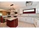 Bright kitchen featuring white cabinets, stylish pendant lights, an island, and stainless appliances at 10713 Stable Dr, Indianapolis, IN 46239