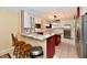 Bright kitchen features white cabinets, stainless appliances, and a breakfast bar with granite countertops at 10713 Stable Dr, Indianapolis, IN 46239