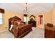 Main bedroom with a chandelier, dresser and elegant furniture with an attached bathroom at 10713 Stable Dr, Indianapolis, IN 46239