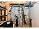 Functional utility room featuring essential systems such as a water heater, water softener, and HVAC unit for home comfort at 10713 Stable Dr, Indianapolis, IN 46239