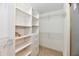 Spacious walk-in closet with custom shelving and wire racks for optimal storage solutions in a well-organized design at 10713 Stable Dr, Indianapolis, IN 46239