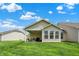 Lush backyard with a covered patio, offering a serene space for relaxation and recreation at 1118 Kristi Ct, Greenwood, IN 46142