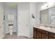 Well-lit bathroom featuring a vanity with a sink and storage cabinets, and a toilet with shelving above at 1118 Kristi Ct, Greenwood, IN 46142