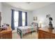Bedroom features a bed with blue curtains, wood furniture and decorations at 1118 Kristi Ct, Greenwood, IN 46142