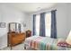 Bedroom featuring a bed, curtains, wood furniture and decorations at 1118 Kristi Ct, Greenwood, IN 46142