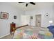 Cozy bedroom features a ceiling fan, ensuite bathroom, and a charming quilt-covered bed at 1118 Kristi Ct, Greenwood, IN 46142