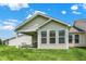 Well-maintained exterior showcases a charming covered patio and landscaped backyard at 1118 Kristi Ct, Greenwood, IN 46142