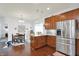 Well-lit kitchen featuring wood cabinets, stainless steel appliances, and an adjacent dining area at 1118 Kristi Ct, Greenwood, IN 46142
