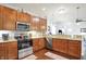 Well-lit kitchen featuring wood cabinets, granite countertops and stainless steel appliances at 1118 Kristi Ct, Greenwood, IN 46142