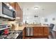Well-lit kitchen featuring granite countertops, stainless steel appliances, and wood cabinets at 1118 Kristi Ct, Greenwood, IN 46142