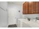 Functional laundry room featuring modern washer and dryer units and ample cabinet storage at 1118 Kristi Ct, Greenwood, IN 46142