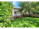 Lovely backyard featuring a wooden deck, mature trees, and a green lawn at 1124 E 35Th St, Indianapolis, IN 46205