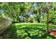 Lush backyard featuring a wood deck, grassy yard, and garden beds at 1124 E 35Th St, Indianapolis, IN 46205