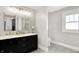 Modern bathroom featuring a double sink vanity, neutral walls, and gray tile floors at 1124 E 35Th St, Indianapolis, IN 46205
