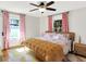 Bedroom featuring hardwood floors, ceiling fan, neutral walls, and natural light at 1124 E 35Th St, Indianapolis, IN 46205