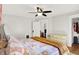 Bright bedroom with a ceiling fan, closet, light-colored dresser, and neutral colored walls at 1124 E 35Th St, Indianapolis, IN 46205
