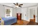 Bright bedroom featuring hardwood floors, neutral walls, and a vintage dresser at 1124 E 35Th St, Indianapolis, IN 46205