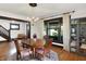 Bright dining room featuring hardwood floors, a chandelier, and a large window with curtains at 1124 E 35Th St, Indianapolis, IN 46205