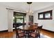 Formal dining room featuring a chandelier, hardwood floors, and a large window at 1124 E 35Th St, Indianapolis, IN 46205
