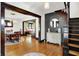 Inviting foyer featuring hardwood floors, a staircase, wall accents, and dining room at 1124 E 35Th St, Indianapolis, IN 46205