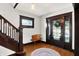 Foyer with staircase, hardwood floors, stained glass window and dark wood trim at 1124 E 35Th St, Indianapolis, IN 46205