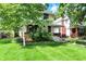 Traditional two-story home showcasing a covered porch, brick accents, and a verdant front yard at 1124 E 35Th St, Indianapolis, IN 46205