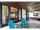 Inviting covered porch with seating, wood ceiling and decorative door with natural lighting at 1124 E 35Th St, Indianapolis, IN 46205