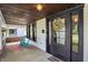 Welcoming covered front porch featuring natural lighting, seating and a decorative front door at 1124 E 35Th St, Indianapolis, IN 46205