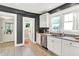 Bright kitchen featuring white cabinets, granite countertops, stainless steel appliances, and tile flooring at 1124 E 35Th St, Indianapolis, IN 46205