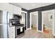 Well-equipped kitchen featuring stainless steel appliances, white cabinets, and modern tile floors at 1124 E 35Th St, Indianapolis, IN 46205