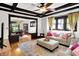 Cozy living room with hardwood floors, coffered ceiling, neutral sofas, and a view into the dining room at 1124 E 35Th St, Indianapolis, IN 46205
