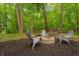 Secluded backyard featuring a fire pit with wooded views at 11243 Catalina Dr, Fishers, IN 46038