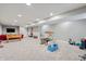 Finished basement with carpeting, a foosball table, TV, and plenty of room for activities and storage at 11243 Catalina Dr, Fishers, IN 46038