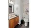 Bathroom with granite countertop, wood cabinet, modern sink, mirror and ceramic tile flooring at 11243 Catalina Dr, Fishers, IN 46038