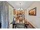 Elegant dining area with hardwood floors, stylish lighting, and convenient kitchen access at 11243 Catalina Dr, Fishers, IN 46038
