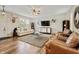 Well-lit living room with hardwood floors, plush seating, and decorative accents at 11243 Catalina Dr, Fishers, IN 46038