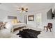 Bright main bedroom features a neutral color palette, wooden bed frame, and ensuite bathroom at 11243 Catalina Dr, Fishers, IN 46038