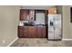 Basement bar area features wine storage and a stainless steel refrigerator at 11323 Still Creek Dr, Zionsville, IN 46077