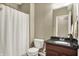 Cozy bathroom with a granite countertop vanity and a white shower curtain at 11323 Still Creek Dr, Zionsville, IN 46077