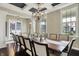 Elegant dining room featuring a coffered ceiling, chandelier, and large windows offering natural light at 11323 Still Creek Dr, Zionsville, IN 46077