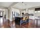 Modern kitchen featuring a large island with seating, stainless steel appliances, and white cabinetry at 11323 Still Creek Dr, Zionsville, IN 46077