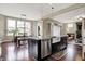 Open concept with modern kitchen island, leading to the Gathering and dining areas at 11323 Still Creek Dr, Zionsville, IN 46077