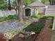 Landscaped backyard with a shed and brick pathway at 1138 E 58Th St, Indianapolis, IN 46220