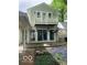 Back of house with a balcony and walkout patio, surrounded by greenery at 1138 E 58Th St, Indianapolis, IN 46220