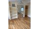 Light-filled bedroom with wood floors, built-in shelves, closet and ample space for relaxation and personalization at 1138 E 58Th St, Indianapolis, IN 46220