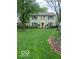 Traditional home featuring a lush front lawn, enhancing the curb appeal and creating an inviting outdoor space at 1138 E 58Th St, Indianapolis, IN 46220